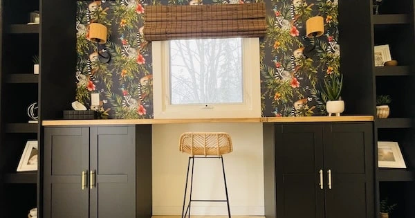 wall to wall custom black built ins with shelves, cabinets and a long wood desk